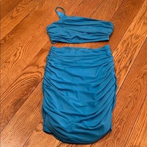 Two piece turquoise skirt and one shoulder shirt.